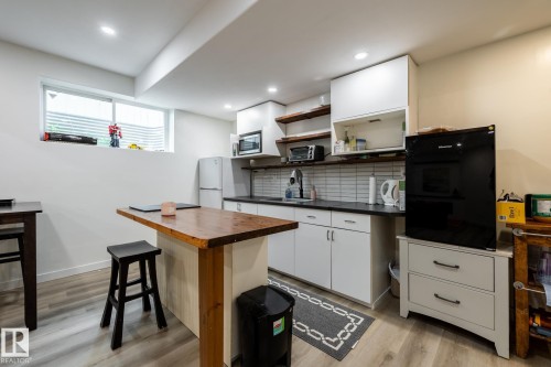 Compact kitchen featuring white cabinetry, dark countertops, and a subway tile backsplash - 2036 Towne Centre Boulevard, Edmonton, AB - Indoor Photo Showing Kitchen