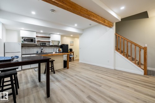 Open-concept living space featuring wood-finish flooring, exposed wood beams, and recessed lighting - 2036 Towne Centre Boulevard, Edmonton, AB - Indoor