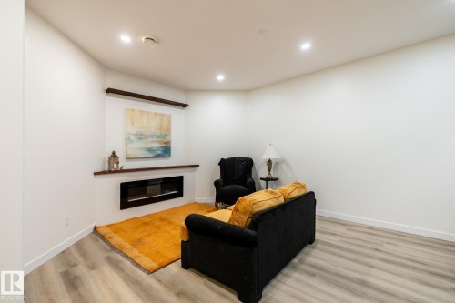 Corner fireplace with dark wood mantel and accent shelf - 2036 Towne Centre Boulevard, Edmonton, AB - Indoor With Fireplace