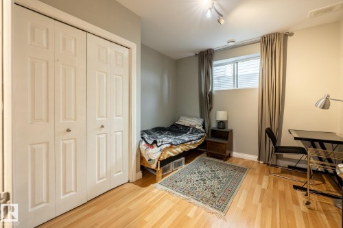 Room featuring wood-finish flooring and a window with blinds - 2036 Towne Centre Boulevard, Edmonton, AB - Indoor Photo Showing Bedroom
