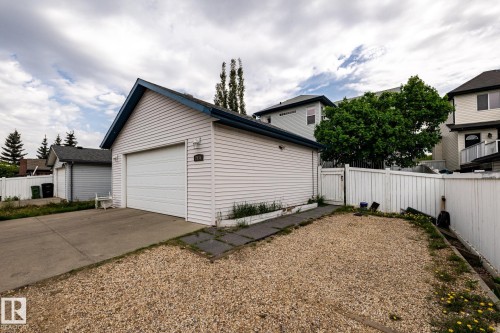 Detached garage with white horizontal siding and a blue-trimmed gable roof - 2036 Towne Centre Boulevard, Edmonton, AB - Outdoor