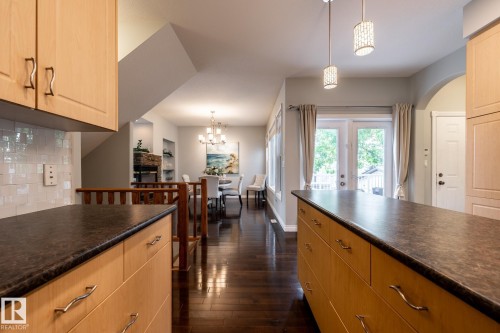 Kitchen with light wood-finish cabinetry, dark countertops, and a white subway tile backsplash - 2036 Towne Centre Boulevard, Edmonton, AB - Indoor Photo Showing Kitchen