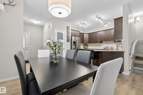 Dining area with wood-finish flooring and a contemporary drum pendant light fixture - 70 James Crescent, St. Albert, AB 