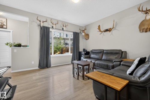 Living area featuring light wood-finish flooring and neutral wall tones - 70 James Crescent, St. Albert, AB 