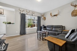 Living area featuring light wood-finish flooring and neutral wall tones - 