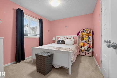 Carpeted room with a ceiling-mounted light fixture - 70 James Crescent, St. Albert, AB 