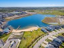 Aerial property highlighting a prominent lake with a sandy beach and a wooden dock - 70 James Crescent, St. Albert, AB 