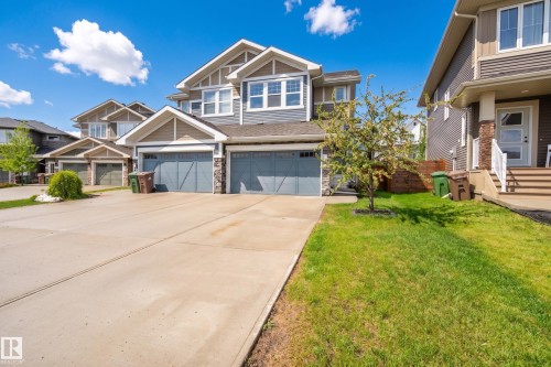 Contemporary multi-level exterior featuring grey siding and stone accents - 70 James Crescent, St. Albert, AB 