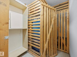 Dedicated storage unit featuring slat-wood construction and a built-in shelving system - 