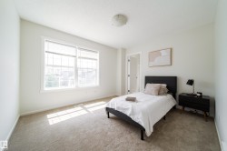 Spacious room with light-toned wall paint and neutral carpeting - 
