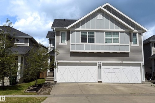 Contemporary gray siding exterior with white trim accents and a prominent front-facing gable - 405 Simmonds Way, Leduc, AB 