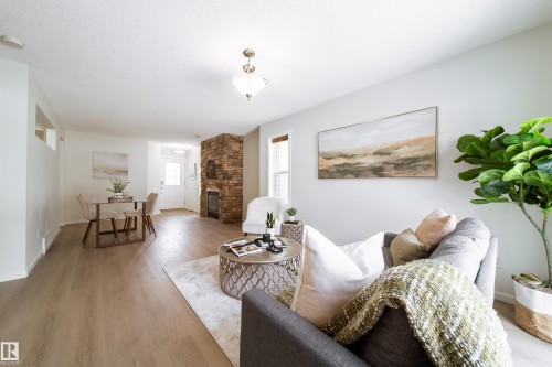 Open-concept living area featuring light wood-finish flooring throughout - 405 Simmonds Way, Leduc, AB 