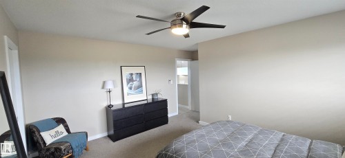 Room featuring neutral wall paint, carpet flooring, and a contemporary ceiling fan with integrated lighting - 4234 46 Street, Vegreville, AB - Indoor Photo Showing Bedroom