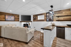 Living area featuring wood-finish flooring and a white paneled ceiling - 