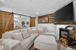 Living area featuring wood-finish flooring and a coffered ceiling - 