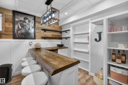 Custom bar area featuring a live-edge wood countertop - 
