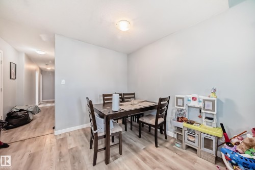 Dining area featuring light wood-finish flooring and a flush-mount ceiling light - 10017 153 Street, Edmonton, AB - Indoor Photo Showing Dining Room