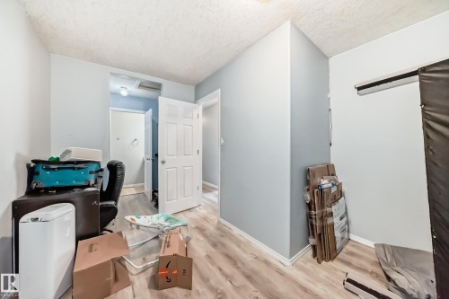 Interior space featuring wood-finish flooring, light blue wall paint, and white trim - 10017 153 Street, Edmonton, AB - Indoor
