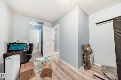 Interior space featuring wood-finish flooring, light blue wall paint, and white trim - 