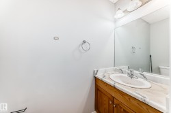Wood-finish vanity with an integrated basin, featuring a patterned countertop - 