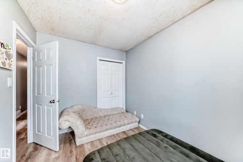 Light blue walls framing wood-finish flooring - 10017 153 Street, Edmonton, AB - Indoor Photo Showing Bedroom