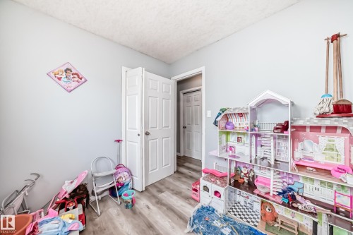 Light gray wall paint complemented by wood-finish flooring - 10017 153 Street, Edmonton, AB - Indoor
