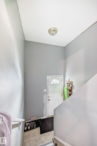 Entryway featuring light gray walls, a white front door with an arched window, and a flush-mount ceiling light fixture - 10017 153 Street, Edmonton, AB - Indoor