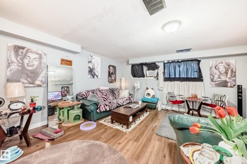 Spacious interior with wood-finish flooring, light grey wall tones, and recessed lighting - 10017 153 Street, Edmonton, AB - Indoor Photo Showing Living Room