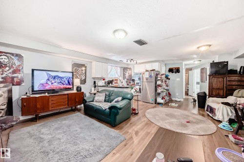 Open-concept living space with wood-finish flooring, recessed lighting, and a neutral wall palette - 10017 153 Street, Edmonton, AB - Indoor Photo Showing Living Room