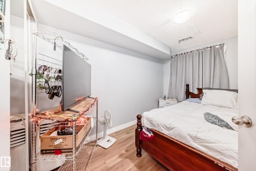 Room with wood-finish flooring, light grey walls, and a recessed ceiling light fixture - 10017 153 Street, Edmonton, AB - Indoor Photo Showing Bedroom