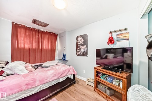 Wood-finish flooring throughout the room - 10017 153 Street, Edmonton, AB - Indoor Photo Showing Bedroom