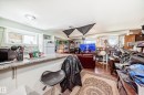 Kitchenette with granite-finish countertop, white cabinetry, and mosaic tile backsplash - 10017 153 Street, Edmonton, AB  - Indoor 