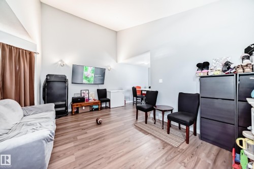 Vaulted ceilings and wood-finish flooring define this open-concept living area - 10017 153 Street, Edmonton, AB - Indoor