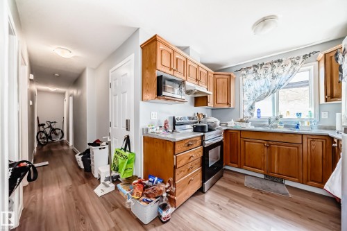 Kitchen with wood-finish flooring and light-toned cabinetry - 10017 153 Street, Edmonton, AB - Indoor Photo Showing Kitchen