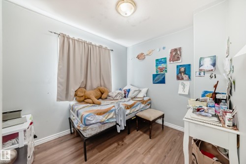 Bedroom featuring wood-finish flooring and a single window with a curtain rod - 10017 153 Street, Edmonton, AB - Indoor