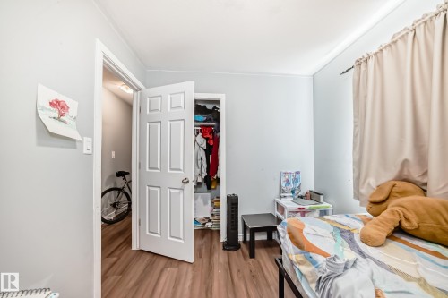 Room featuring wood-finish flooring, light blue wall paint, and white trim - 10017 153 Street, Edmonton, AB - Indoor Photo Showing Bedroom