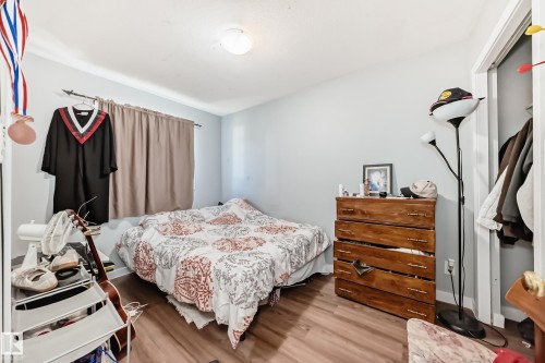 Bedroom featuring wood-finish flooring, light grey walls, and a recessed ceiling light - 10017 153 Street, Edmonton, AB - Indoor Photo Showing Bedroom