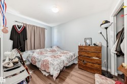 Bedroom featuring wood-finish flooring, light grey walls, and a recessed ceiling light - 