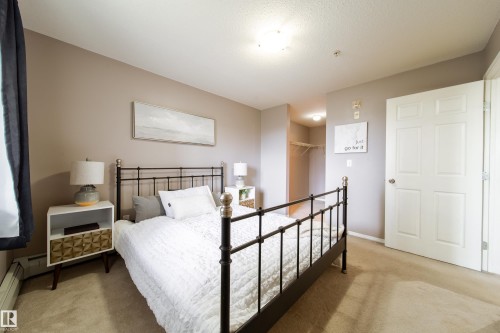 Carpeted room with neutral wall tones and a white four-panel door - 115 4309 33 Street, Stony Plain, AB 