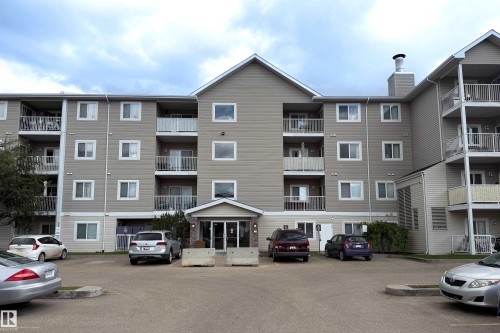 Multi-story apartment building with beige horizontal siding and white trim - 115 4309 33 Street, Stony Plain, AB 