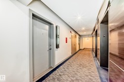 Hallway featuring recessed lighting, a patterned carpet runner, and contemporary apartment entry doors - 