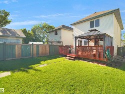 Expansive green lawn with a privacy fence - 