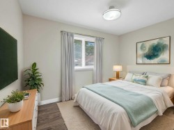 Bedroom featuring wood-finish flooring, a contemporary ceiling light fixture, and a window with blinds - 