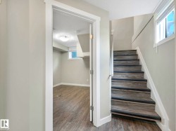 Wood-finish stairs with dark tread accents - 