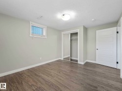 Light gray wood-finish flooring complements soft gray walls - 