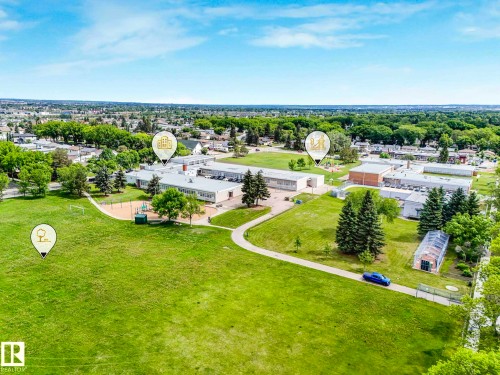 Expansive green space with manicured lawns and mature trees - 12241 54 Street, Edmonton, AB 