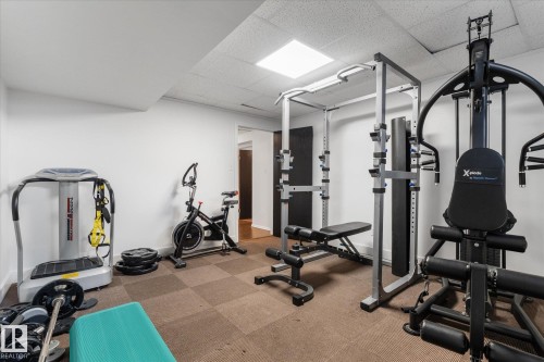 Dedicated fitness space featuring white walls and a grid-patterned floor - 18 Woodbend Way, Fort Saskatchewan, AB 