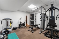 Dedicated fitness space featuring white walls and a grid-patterned floor - 