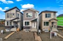 Contemporary multi-level residence featuring a neutral-toned facade with vertical and horizontal siding - 4213 63 Street, Beaumont, AB 