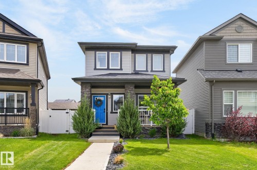 Two-story dwelling with gray horizontal siding and black trim windows - 17733 64A Street, Edmonton, AB 